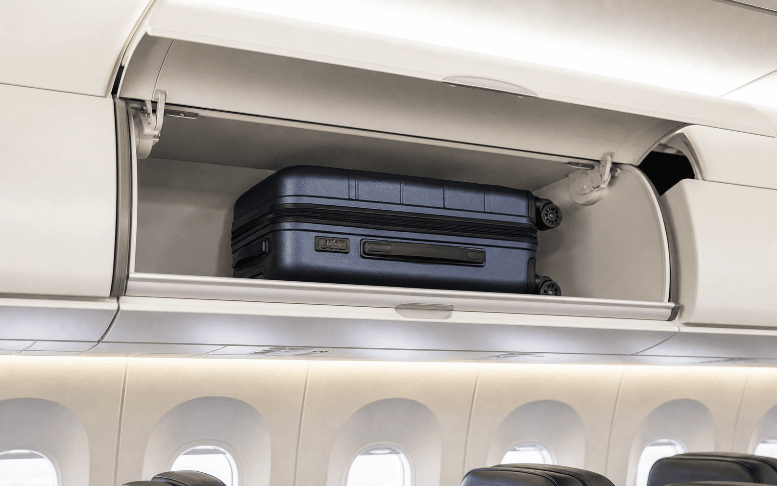 Carry-on suitcase placed inside an airplane overhead bin